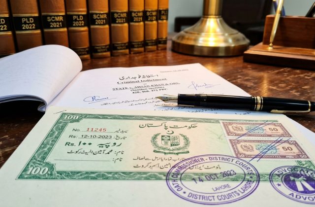 Macro view of authentic Pakistani court stamp paper, judicial fee tickets, official seals, and legal reporter volumes for NAB and FIA white collar crime proceedings